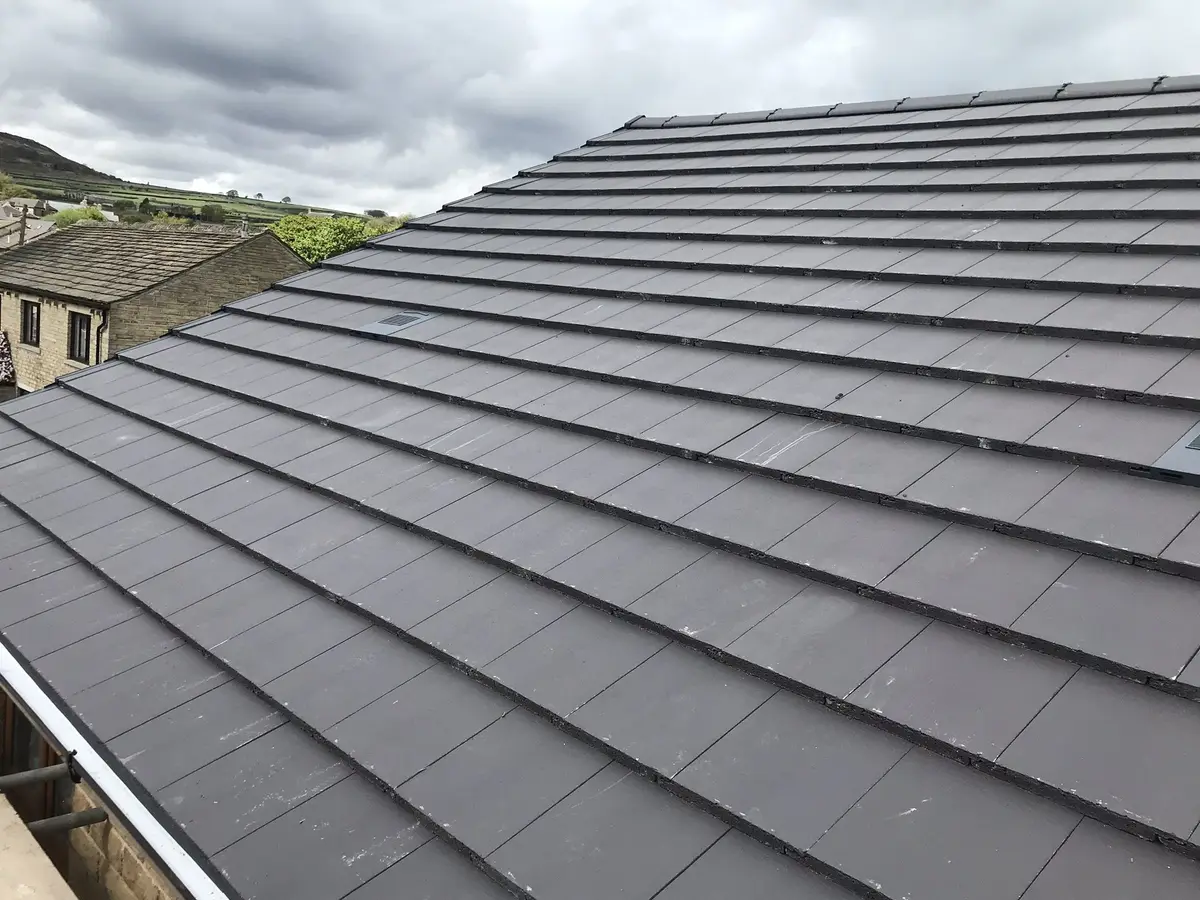 A Broomhill Roofing roofer laying new concrete tiles